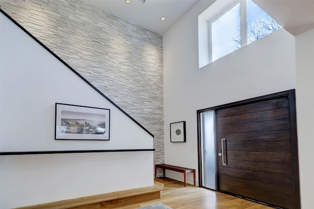 entryway featuring a high ceiling and light wood-type flooring