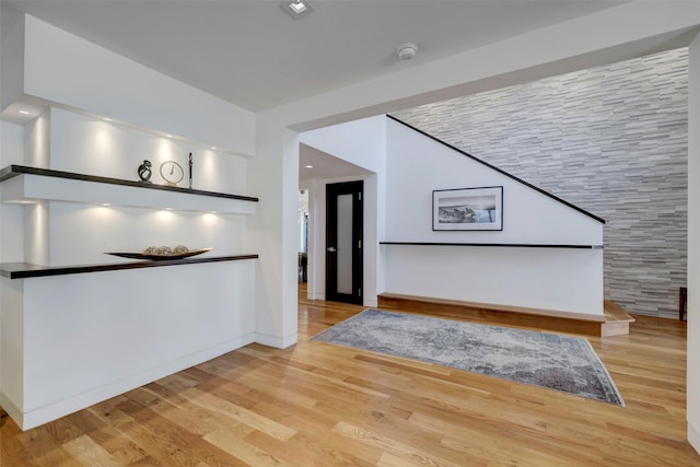 interior space featuring light hardwood / wood-style flooring and vaulted ceiling