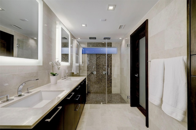 bathroom with tile walls, vanity, tasteful backsplash, and an enclosed shower