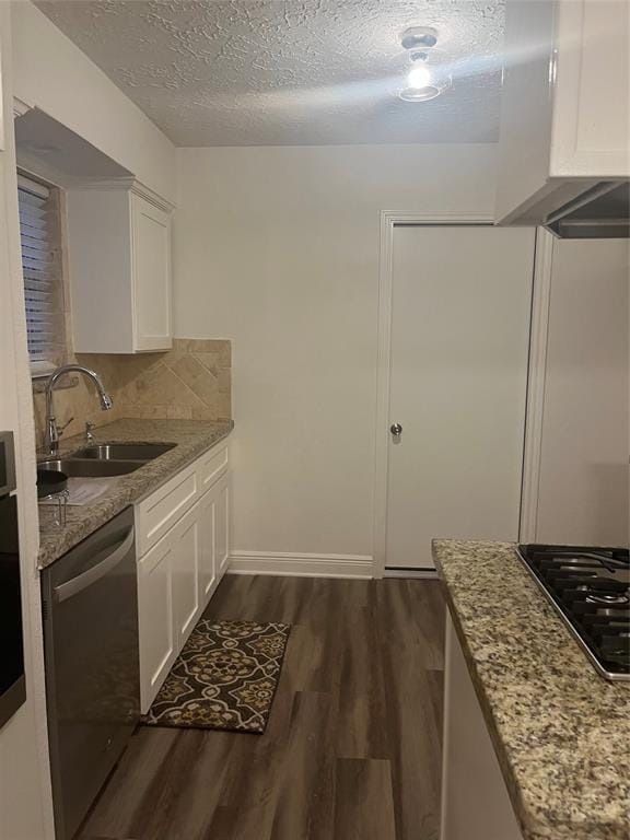 kitchen with sink, white cabinets, stainless steel dishwasher, and light stone countertops