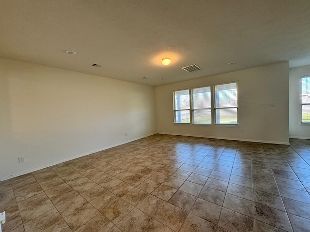 unfurnished room featuring light tile patterned flooring