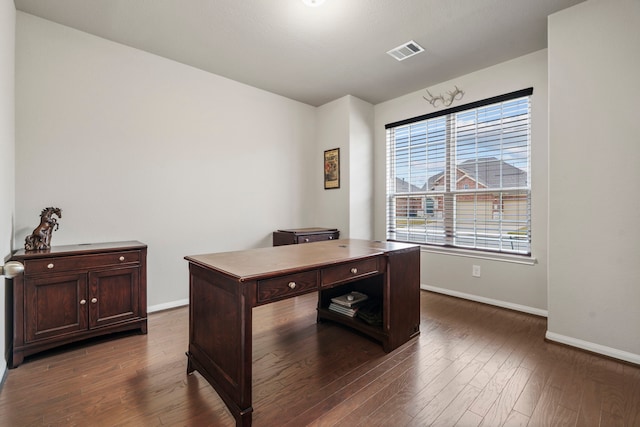 office space with dark wood-type flooring