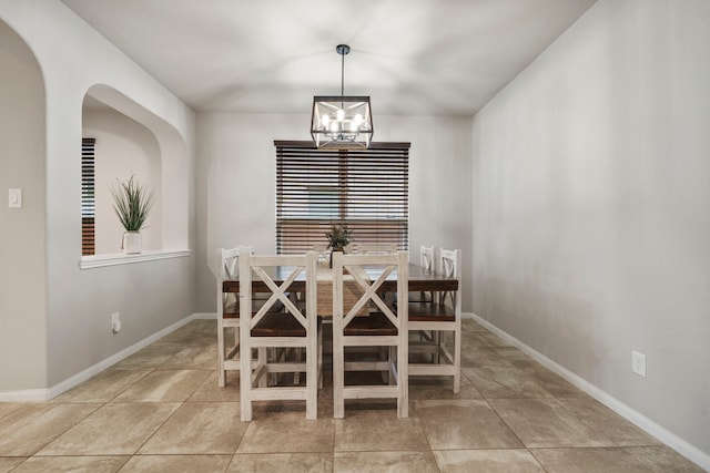 tiled dining space with an inviting chandelier