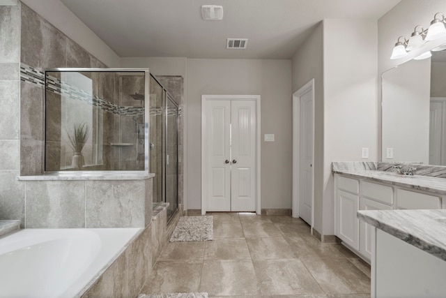 bathroom with vanity and separate shower and tub