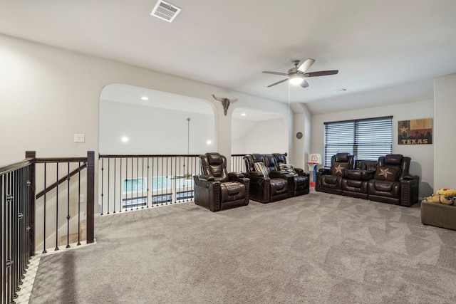 carpeted living room with ceiling fan