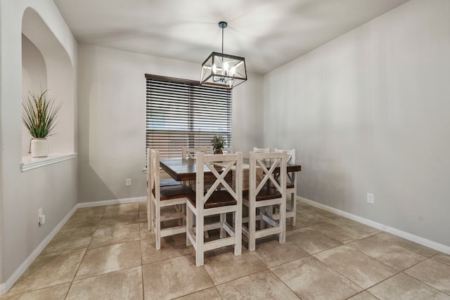 dining area with an inviting chandelier and light tile patterned floors