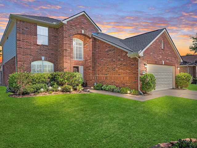 front of property featuring a garage and a lawn