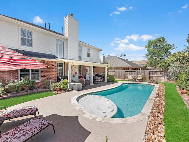 view of swimming pool with a patio