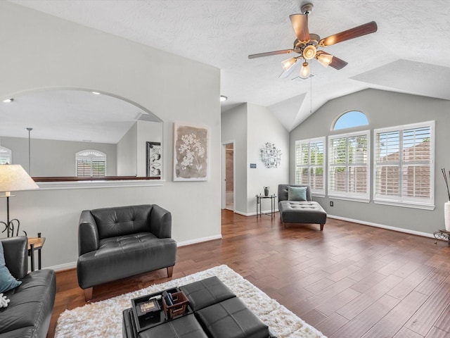 living room featuring ceiling fan, dark hardwood / wood-style floors, a textured ceiling, and lofted ceiling