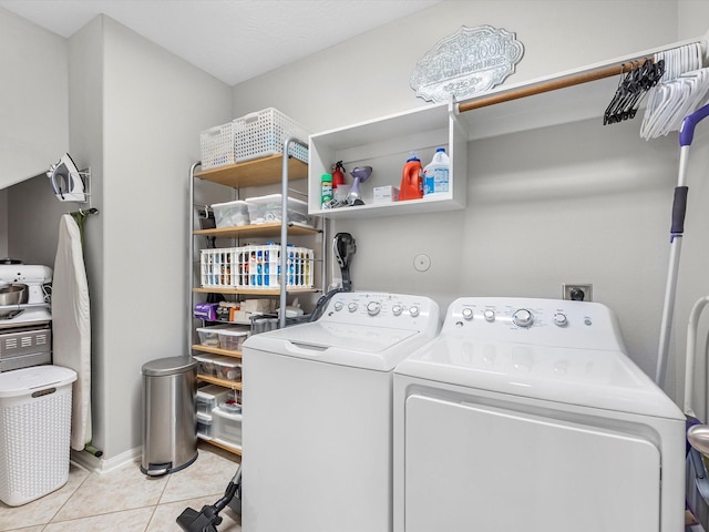 laundry area featuring light tile patterned flooring and separate washer and dryer