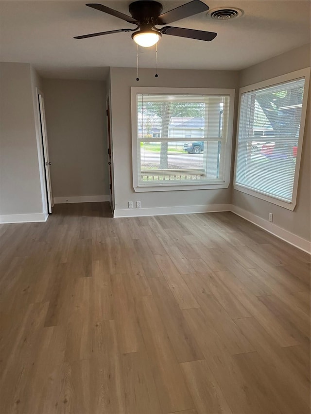 spare room with ceiling fan and light hardwood / wood-style floors