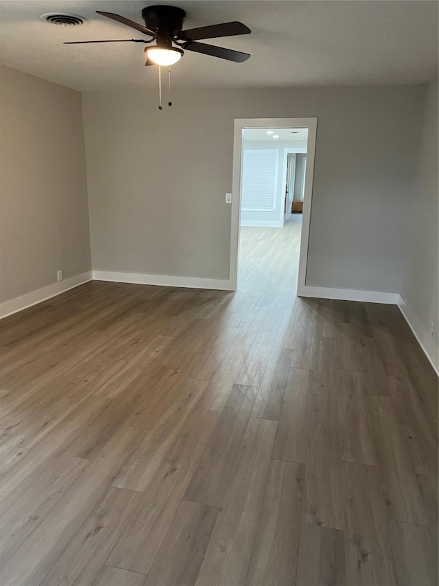 spare room featuring hardwood / wood-style flooring and ceiling fan