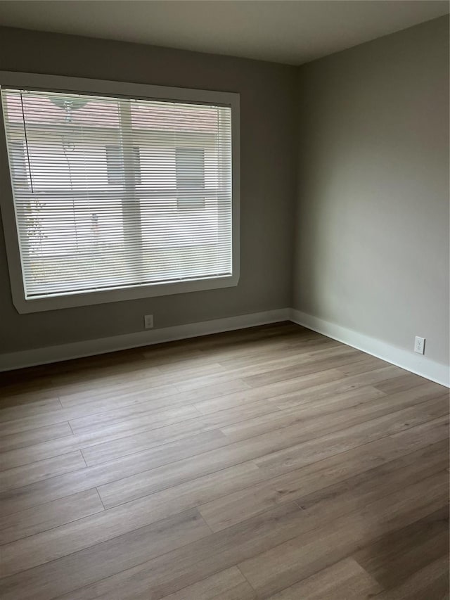 unfurnished room with light wood-type flooring