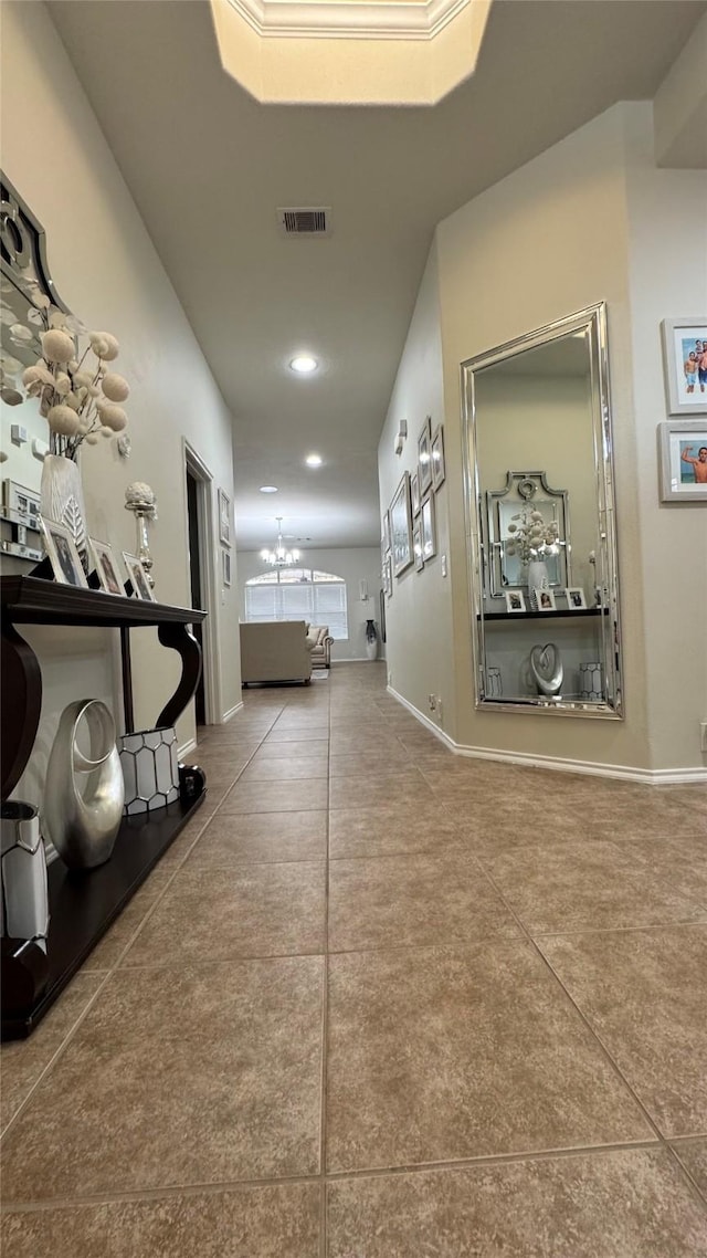 corridor with an inviting chandelier