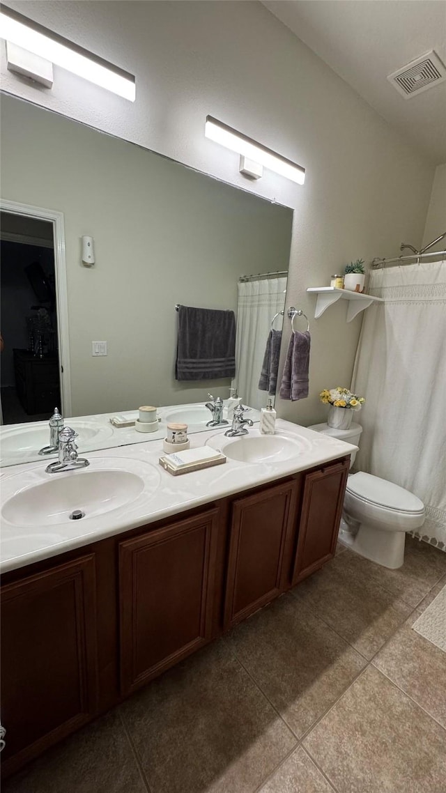 bathroom with tile patterned floors, toilet, and vanity