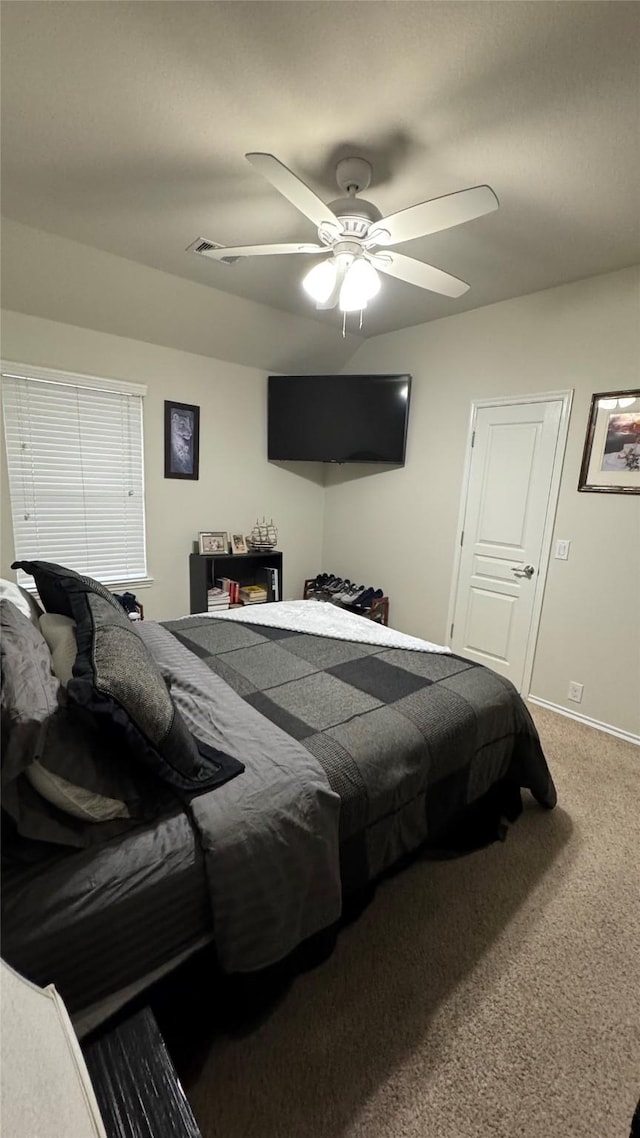 bedroom featuring ceiling fan and carpet