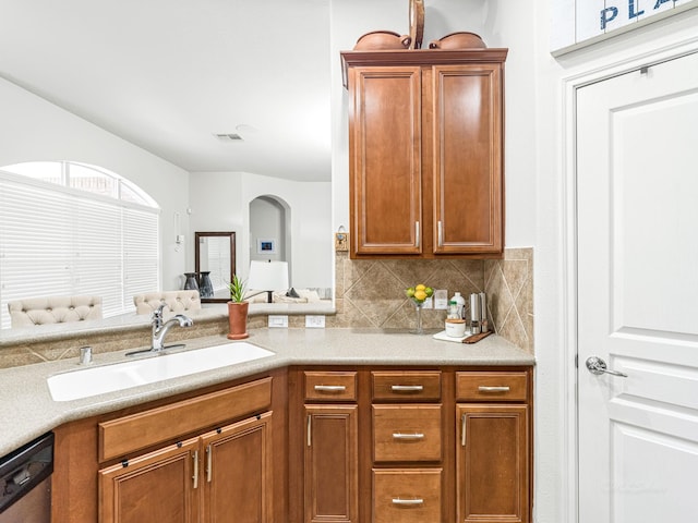 kitchen featuring tasteful backsplash, sink, and stainless steel dishwasher