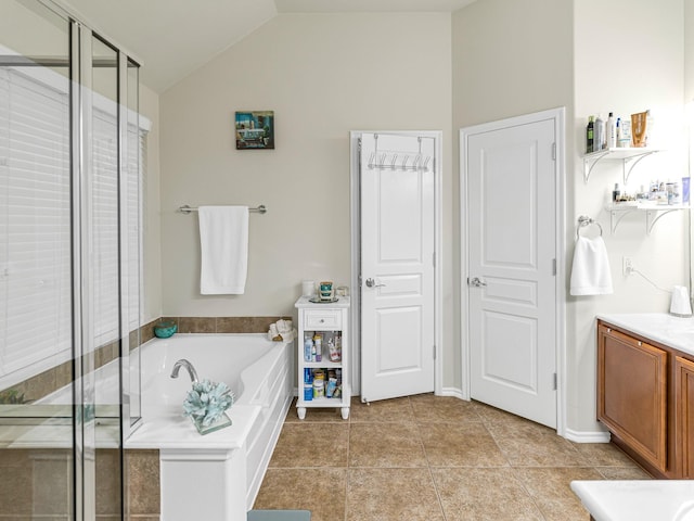 bathroom with tile patterned flooring, vanity, independent shower and bath, and vaulted ceiling