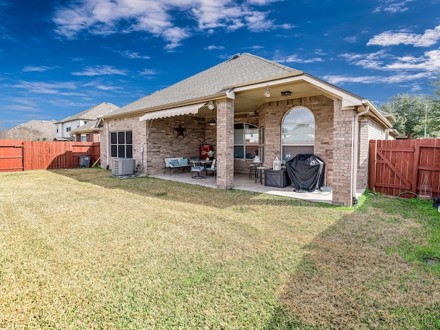 back of property featuring cooling unit, a yard, and a patio area