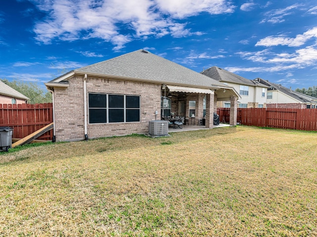 back of property featuring central AC unit, a yard, and a patio area