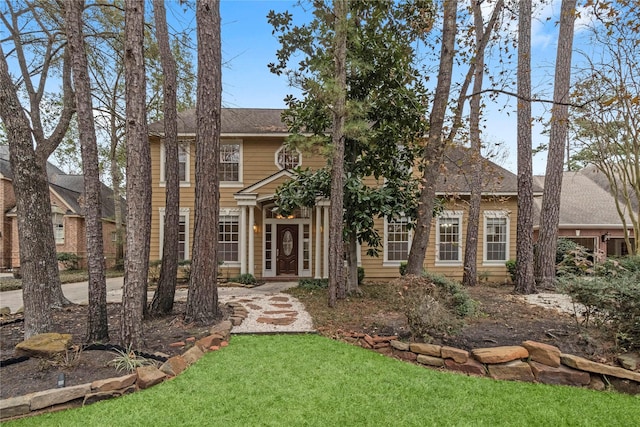 colonial home with a front lawn