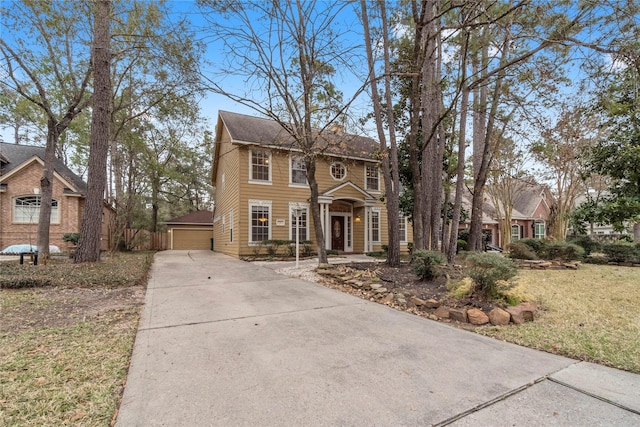 view of front of house featuring a garage, an outdoor structure, and a front yard