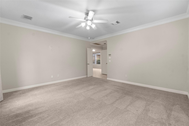 carpeted spare room featuring crown molding and ceiling fan