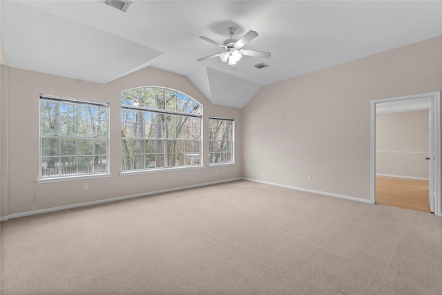 unfurnished room with lofted ceiling, light colored carpet, and ceiling fan