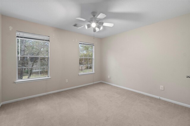 carpeted spare room with ceiling fan