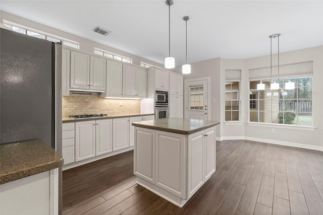 kitchen with white cabinetry, a kitchen island, and pendant lighting