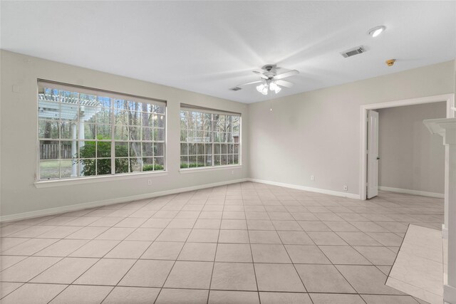 empty room with light tile patterned floors and ceiling fan