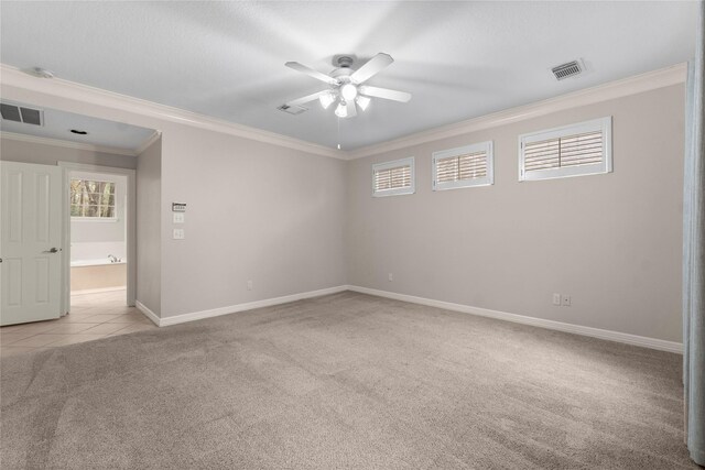 spare room with crown molding, ceiling fan, and light carpet