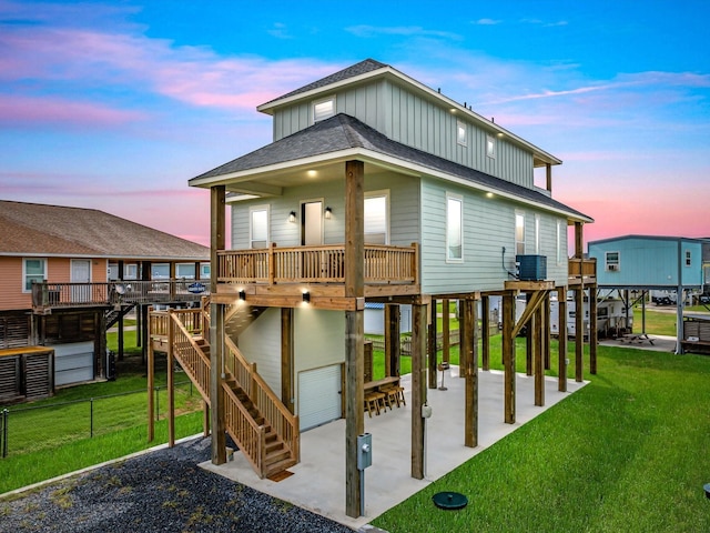 playground at dusk with cooling unit, a lawn, and a patio