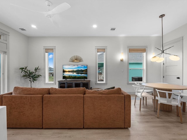 living room featuring ceiling fan and light hardwood / wood-style flooring