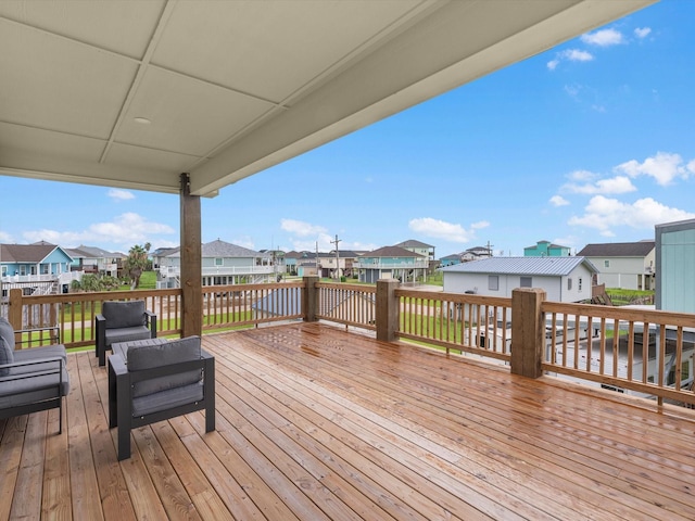 deck featuring a water view and outdoor lounge area