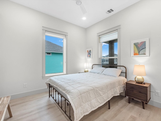 bedroom with light hardwood / wood-style floors and ceiling fan