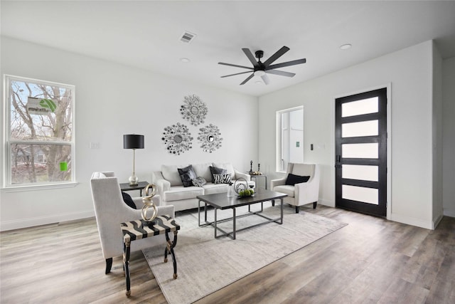 living room with hardwood / wood-style floors and ceiling fan