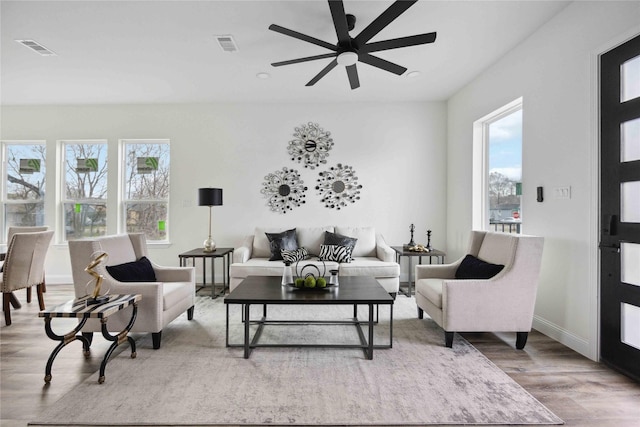 living room with ceiling fan and light hardwood / wood-style floors