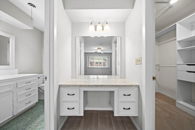 bathroom with vanity, toilet, and ceiling fan