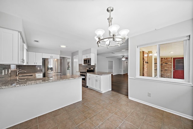 kitchen with white cabinets, stainless steel appliances, and kitchen peninsula