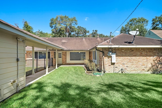 rear view of house with a lawn