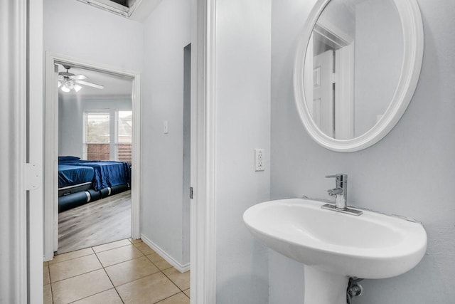 bathroom with tile patterned flooring, sink, and crown molding