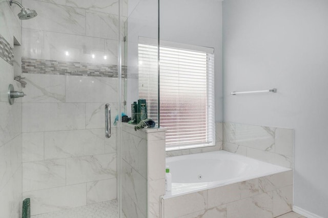 bathroom featuring separate shower and tub