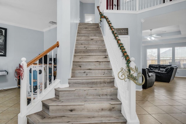 staircase featuring crown molding, tile patterned floors, and ceiling fan