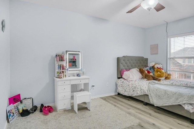 bedroom with light wood-type flooring and ceiling fan