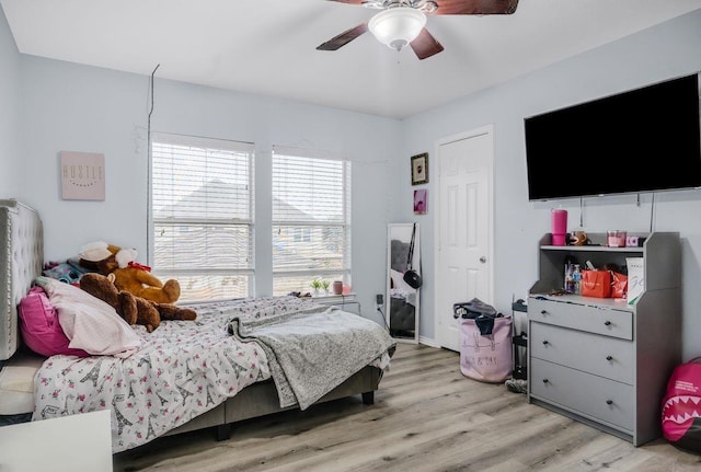 bedroom with ceiling fan and light hardwood / wood-style flooring