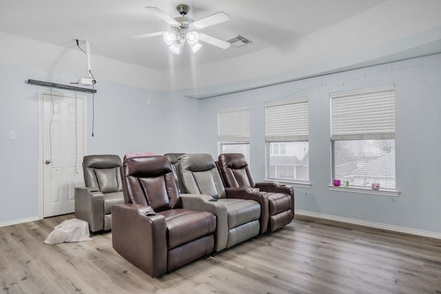 home theater room featuring ceiling fan and light hardwood / wood-style floors