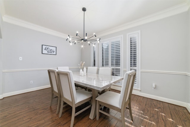 dining space with dark hardwood / wood-style floors, crown molding, and an inviting chandelier