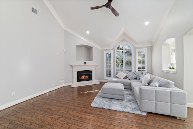 living room featuring ceiling fan, dark hardwood / wood-style floors, crown molding, and vaulted ceiling