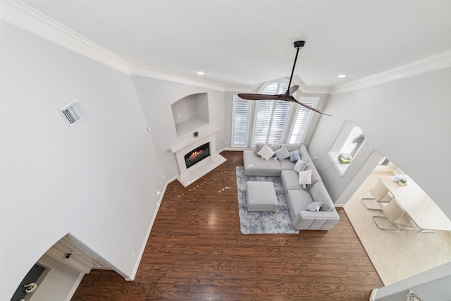 living room with ceiling fan, crown molding, and dark hardwood / wood-style floors